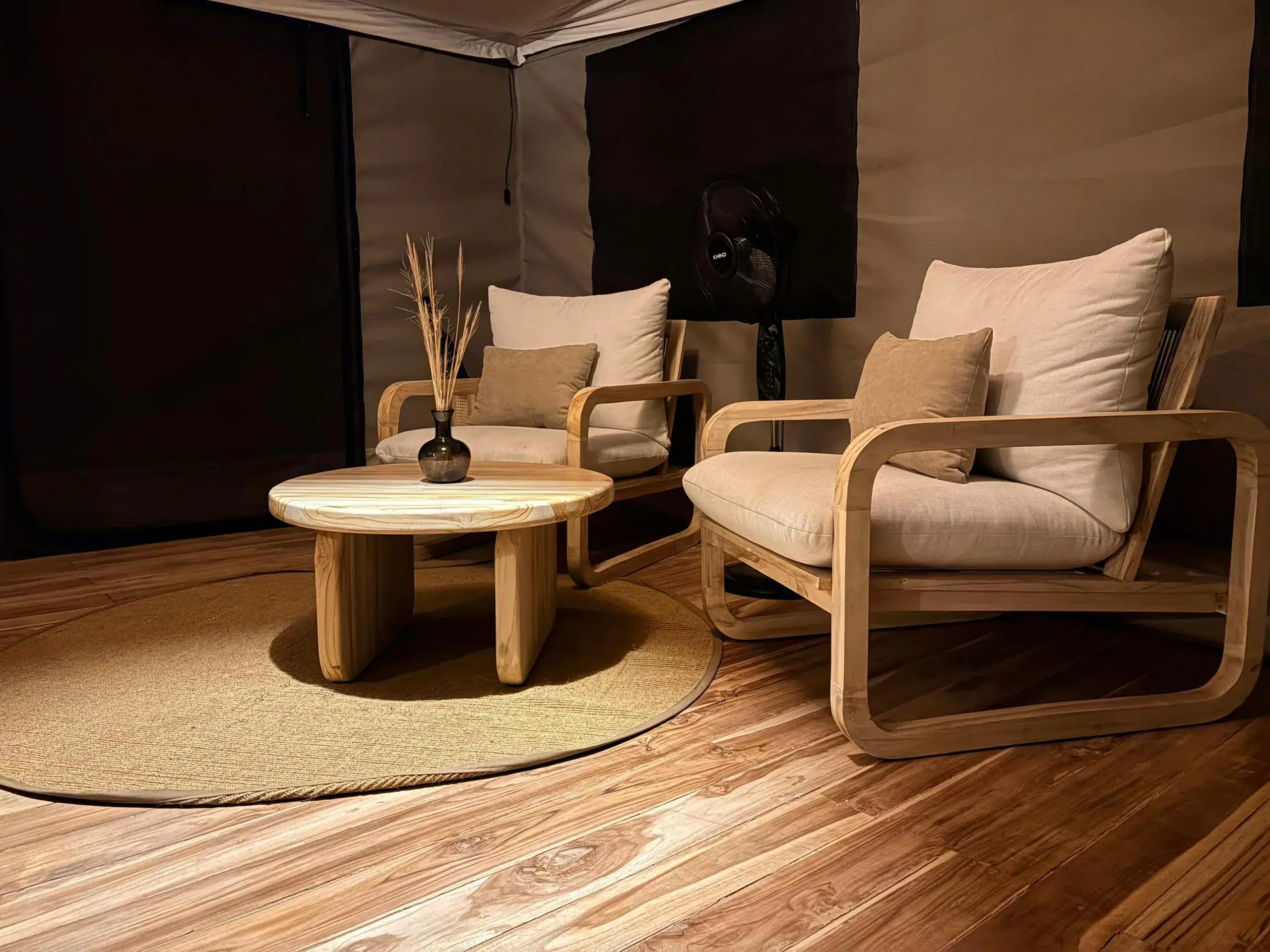 Lounge corner with armchairs inside a safari tent